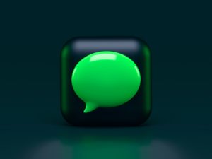 A green speech bubble depicted on a dark background.