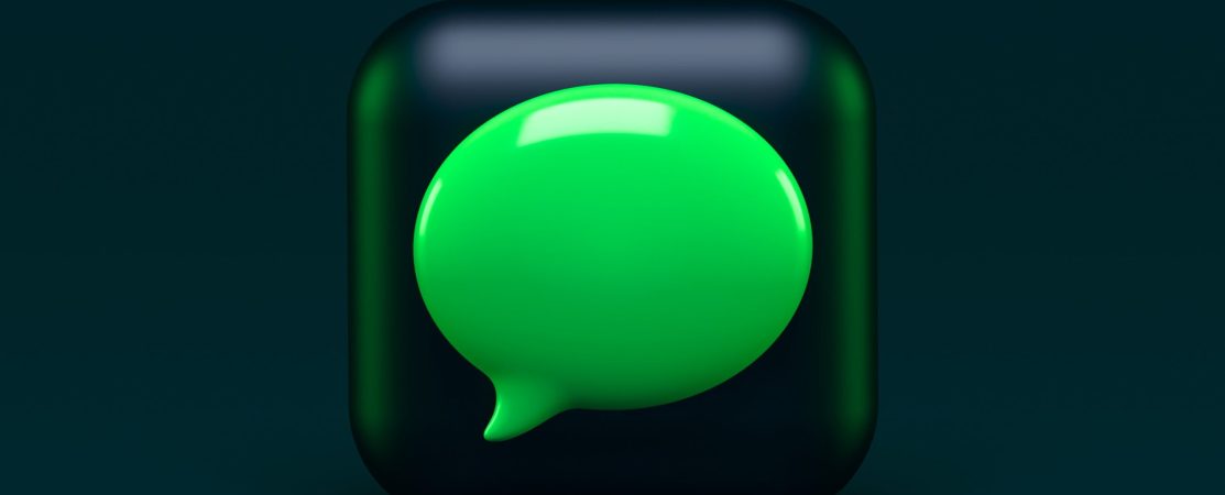 A green speech bubble depicted on a dark background.